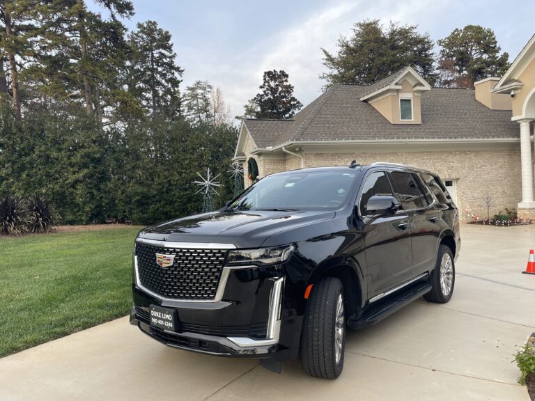 Black Cadillac Escalade SUV parked in front of a luxury home, representing premium travel agent limo service for VIP clients. Ideal for airport transfers, private charters, and executive transportation.