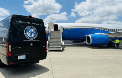Duke Limo luxury Sprinter van positioned beside private jet on airport tarmac – exclusive VIP ground transportation service.