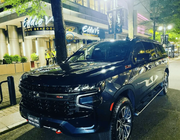 Duke Limo black SUV parked at Eddie V's in Charlotte – luxury airport car service and limo for special nights out"