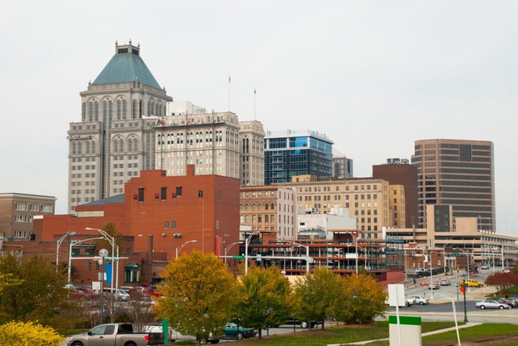 Skyline of Greensboro featuring the green‑roofed tower, surrounding buildings and autumn trees—one of the many areas served by Greensboro limo service across central North Carolina.