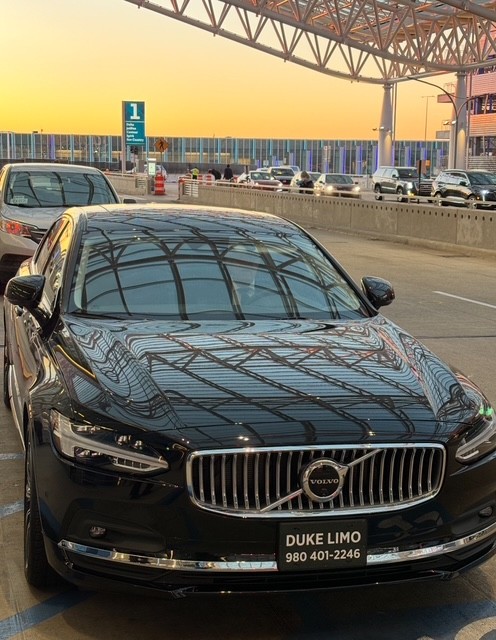 Duke Limo black car parked at Charlotte Douglas International Airport – Cornelius NC Limo Service airport transfer.