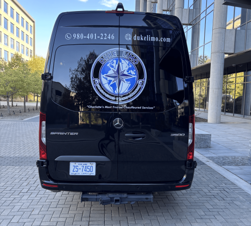 Rear view of Duke Limo luxury Sprinter van with branded logo and contact information – serving executive and airport travelers across Charlotte.