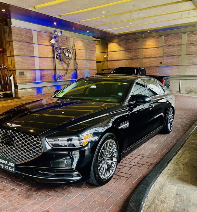 Luxury black Genesis sedan from Duke Limo parked at hotel entrance in Charlotte, NC, ready for private executive car service or VIP pickup.