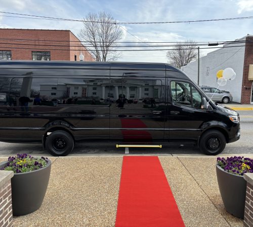Duke Limo luxury Sprinter van with red carpet entry setup – perfect for weddings, VIP events, and upscale group transportation.